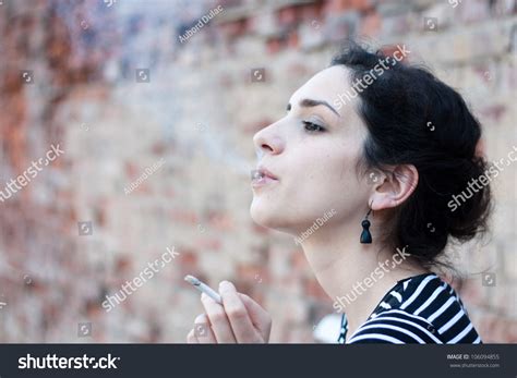 Portrait Of A Beautiful Young Woman Smoking Stock Photo