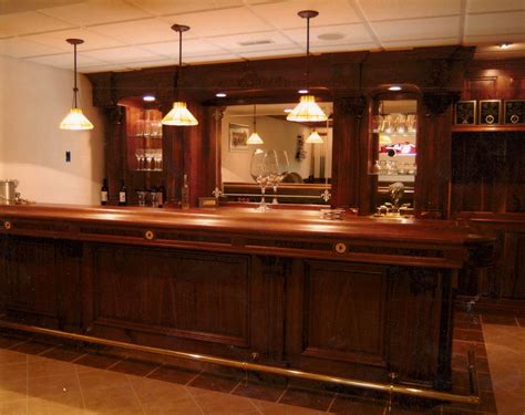 A Large Wooden Bar With Three Lights Hanging From Its Sides In A Room
