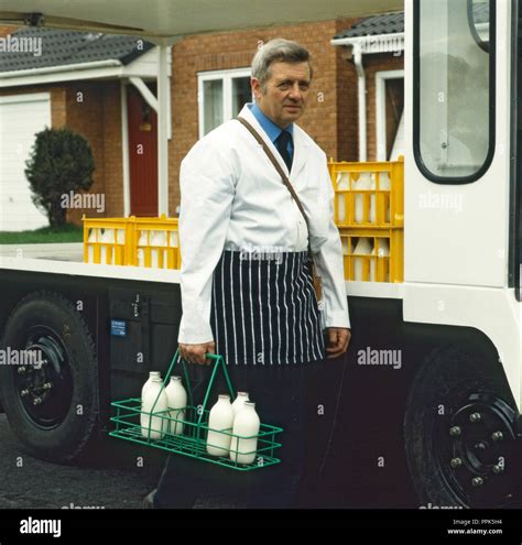 Doorstep Milk Delivery With Milkman And Milk Float Stock Photo Alamy