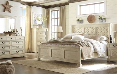 The set includes a bed, two cabinets, a dresser with a mirror. Bolanburg White Panel Bedroom Set, B647-54-57-96, Ashley