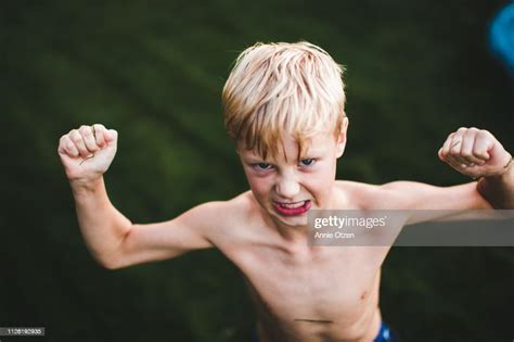 Boy Flexing His Muscles Photo Getty Images