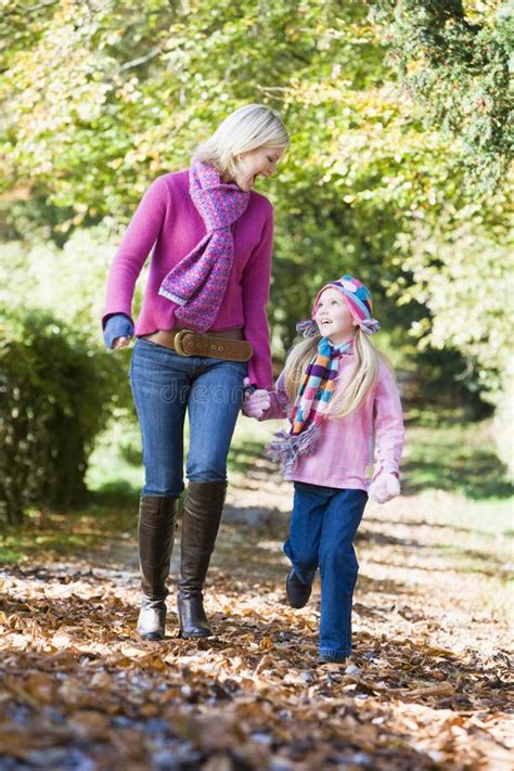 Mother And Daughter Walking Along Autumn Path Stock Image Image Of