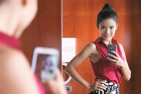 mirror selfie confident asian woman feeling pretty good in her body taking photo with mobile