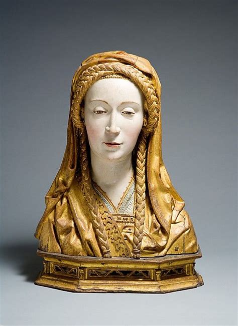 A Statue Of A Woman Wearing A Gold Headdress