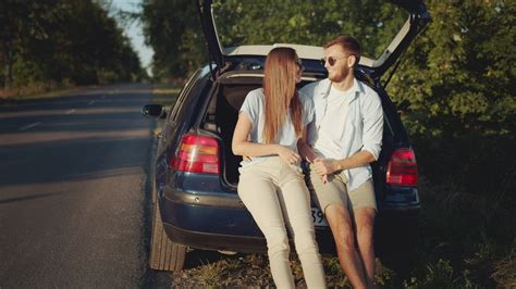 Young Couple Kiss In Back Of Car In Sunny Countryside Free Stock Video