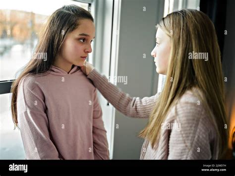 Teenage Girl Consoling Her Sad Friend On Her Bedroom Stock Photo Alamy