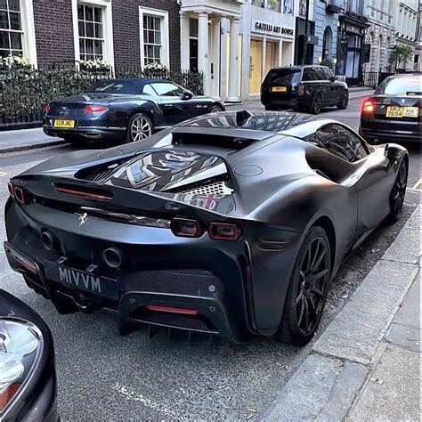 The Black Sports Car Is Parked On The Side Of The Street