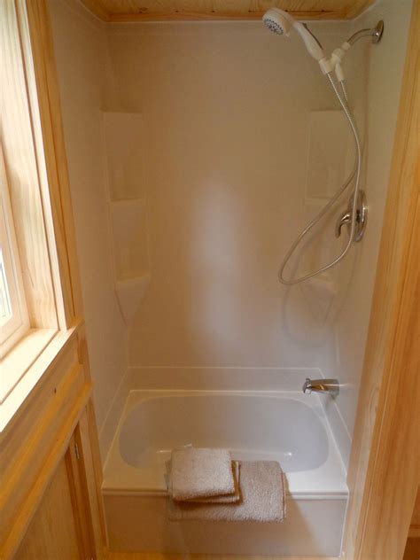 Freestanding deep soak tub and shower combo installation tips with limited space. Small Shower Tub for Tiny Houses - DECOREDO