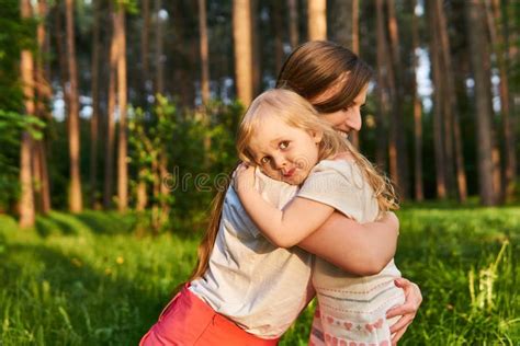 Toddler Daughter Hugs Her Mom Outdoors Stock Image Image Of Parent