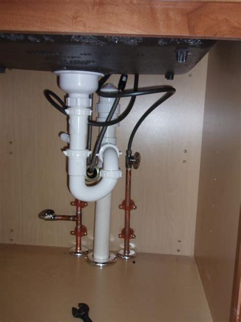 Trouble connecting water inlet connection to plastic pipe. Newly installed kitchen sink drain and water lines from ...