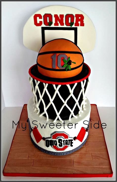 The Bottom Tier Is Covered In Buttercream With Fondant Decorations The Top Tier And Basketball