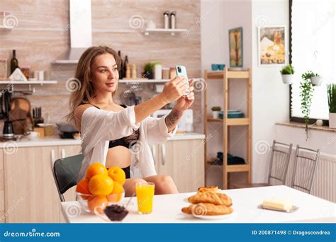 Sensual Woman Taking Photosin Kitchen Stock Photo Image Of Sitting