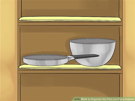 Organizing pots and pans in cabinet. How to Organize the Pots and Pans Cabinet: 14 Steps