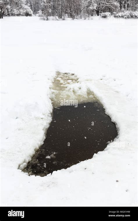 Ice Hole In Frozen Pond In Urban Timiryazevskiy Park In Moscow City In