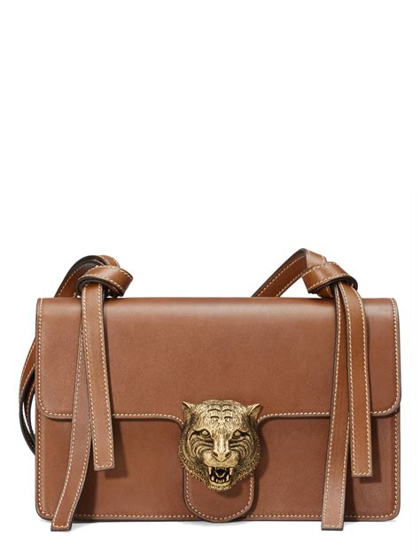 A container of flexible material, such as paper, plastic, or leather, that is used for carrying or. Lyst - Gucci Tiger Lock Shoulder Bag in Brown