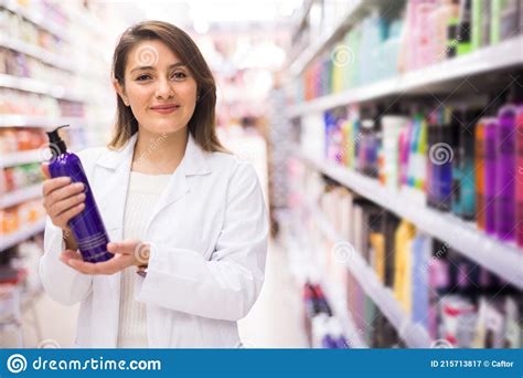 Positive Salesgirl Helping To Choose Hair Products In Cosmetic Store