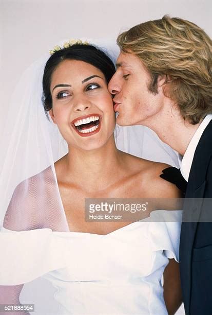 Groom Kissing Bride On Cheek Photos And Premium High Res Pictures