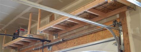 A hoist is a great way to create garage storage overhead or for garage bike storage.a plastic grillwork screwed into the corner of a garage or basement under the ceiling will be great to store pvc pipes, baseboards, profil DIY: How to Build Suspended Garage Shelves - Building Strong