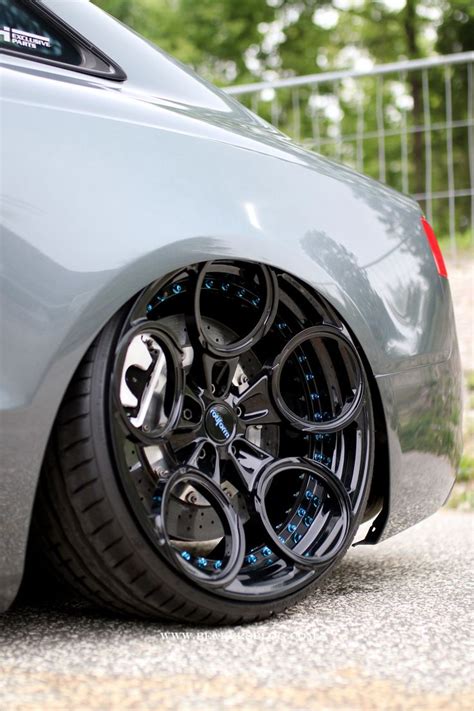 The Front Wheel Of A Car With Black Rims