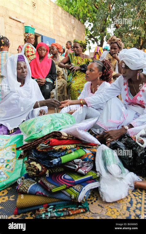 In Ouagadougou Burkina Faso Women Bring Ts Of Clothing To A Child