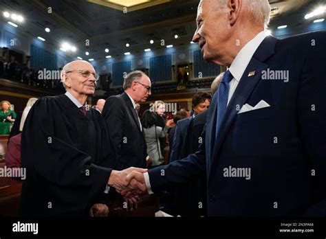 President Joe Biden shakes hands with retired Justice Stephen Breyer