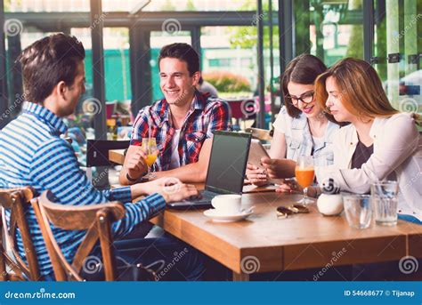 Group Of Young People Sitting At A Cafe Talking Stock Image Image Of