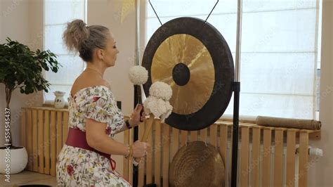 Gong And Gong Mallets Indoor Woman Taps The Gong With Soft Hammers