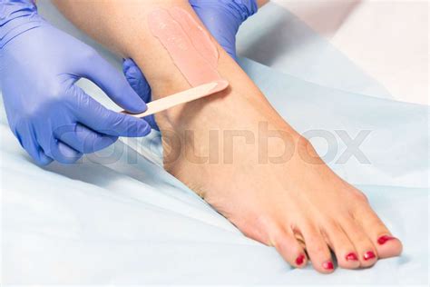 The Process Of Classical Wax Depilation Of Female Limbs In The Beauty Salon Stock Image