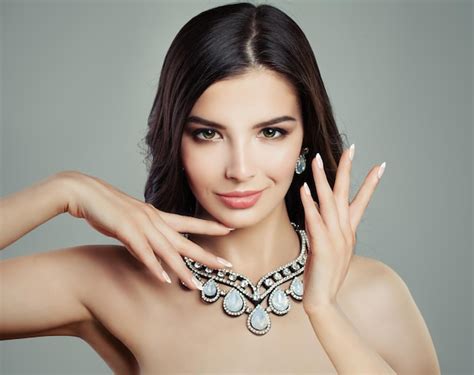 Premium Photo Brunette Woman In Jewelry Necklace On Gray Background Makeup Hands With French