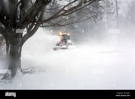Snowblower Blowing Snow From Driveway During Blizzard Stock Photo Alamy
