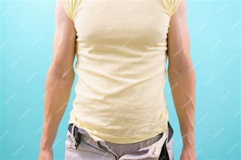 Premium Photo A Man In Unbuttoned Jeans Stands On A Blue Background