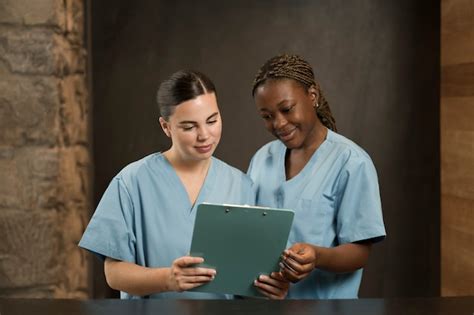 Premium Photo Two Female Nurses Working At The Clinic In Scrubs