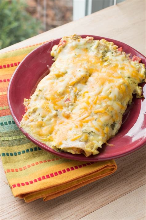 In a large bowl, combine chicken, 1/2 cup enchilada sauce, 1/2 cup cheese, sour cream, cilantro and diced green chiles. Skinny Sour Cream Chicken Enchiladas