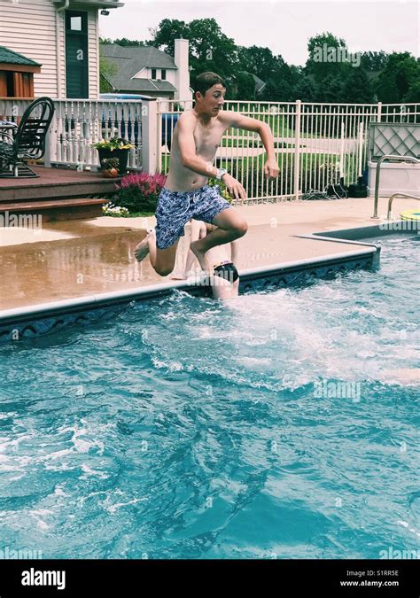 Teen Boy Jumping In Pool Stock Photo Alamy