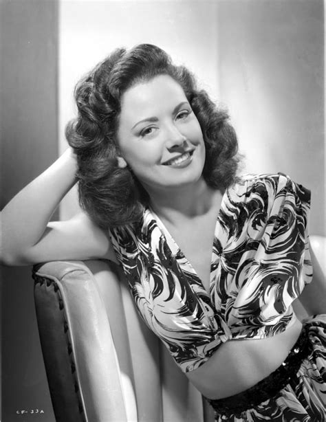 Carol Forman Wearing A Printed Dress With Head Leaning On Hand Photo