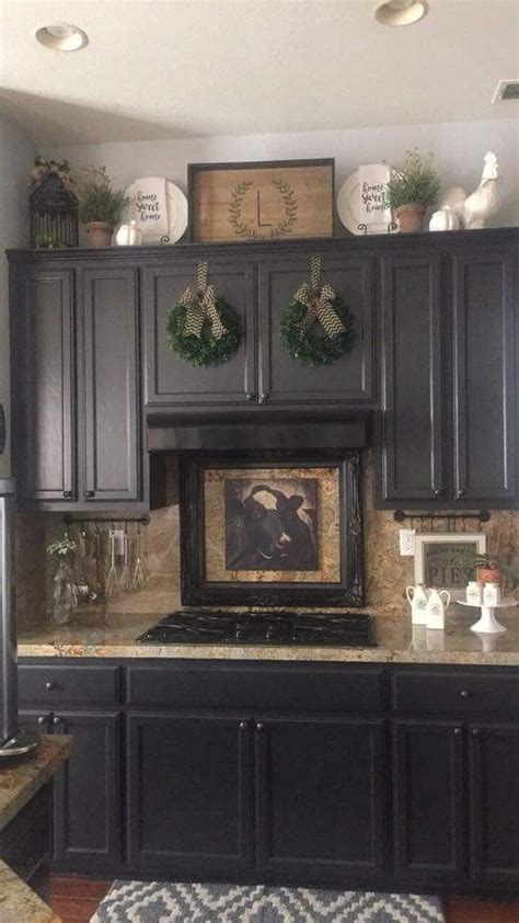One of the best small kitchen decorating ideas is to coordinate matching colored smaller pieces throughout using glass for your cabinet doors is a unique way to display everything. Kitchen #kitchencabinetdesignideas | Decorating above ...