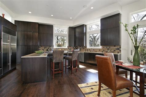 Choosing a wood floor for the kitchen can better connect the eating area with other rooms in your home. 43 Kitchens with Extensive Dark Wood Throughout