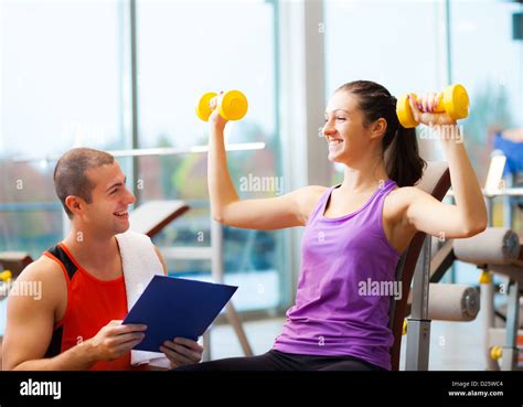 Personal Trainer Explaining An Exercise To A Woman Stock Photo Alamy
