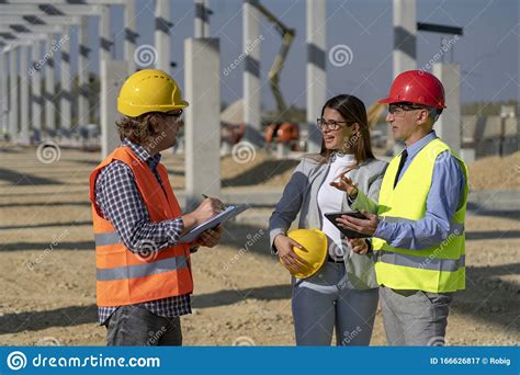 Construction Business Team Standing And Talking On Site Under