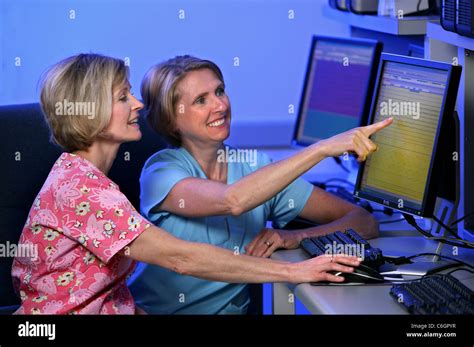 Two Nurses Look Over Medical Information Stock Photo Alamy