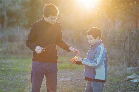 Older Brother Helping Younger Brother Photograph By Alexandra C