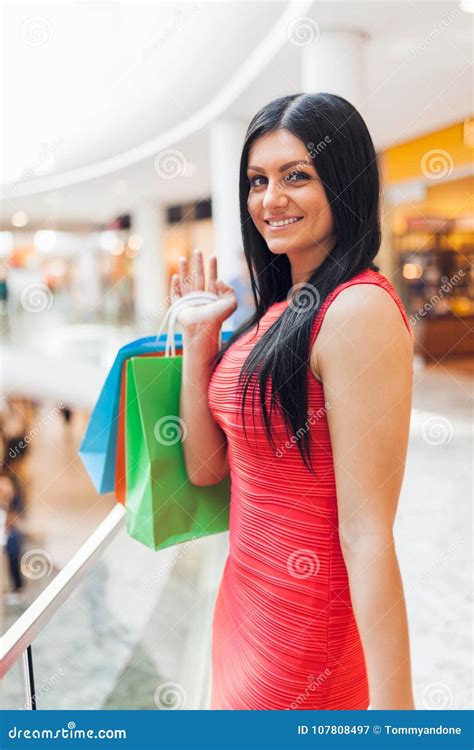 Mulher Bonita Com Os Sacos De Compras Na Alameda Imagem De Stock
