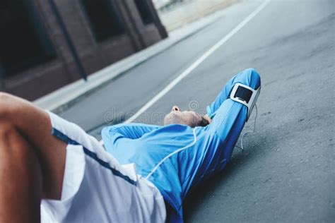 Tired Athlete Lying On The Street After Bad Workout Session Stock Image