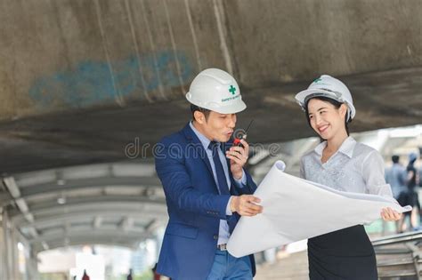 Engineering Man And Women With Blueprint Architecture Plan Construction