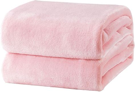 A Pink Blanket Folded On Top Of Each Other