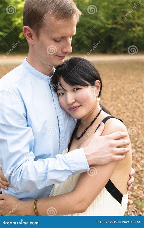 Romantic International Couple In Beautiful Park Hugging Each Other Stock Image Image Of Green