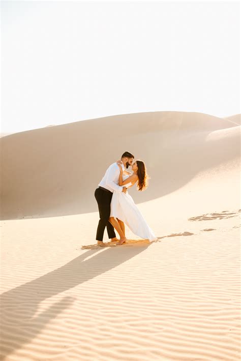 golden sand dunes engagement session sand dunes photoshoot desert engagement photos funny