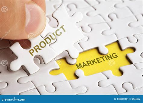 Hand Holding Piece of Puzzle with Word PRODUCT MARKETING. Stock Image
