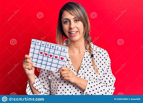 Young Beautiful Woman Holding Period Calendar Looking Positive And