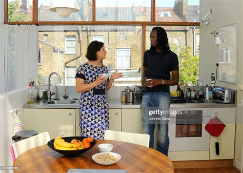 Mature Mixed Race Couple Chatting In The Kitchen High Res Stock Photo